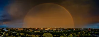 I was at home looking outside to the nice sky building up. It was raining heavily a few minutes ago. Now it is dry and I see a rainbow and this time it is complete. Also the second rainbow can be seen very subtly. I grabbed my DJI Mini 4 pro and lifted it up from our garden and made this panorama shot.