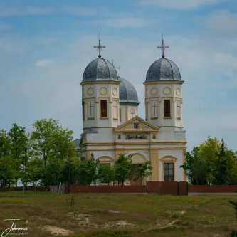 A beautiful example of regional religious architecture. The bright facade and distinctive twin domes stand as a timeless landmark against the rural landscape, a testament to enduring faith and community history.