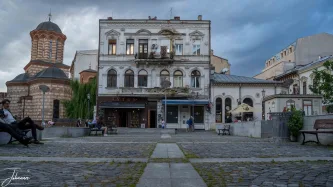 Time stands still in this cobbled square where centuries of history meet. The worn facades, the intricate church, and the evening light blend to create a portrait of a city both grand and beautifully faded.