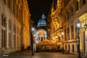 Bathed in the warm glow of evening, this historic Bucharest street guides the eye straight to the magnificent dome of the National Bank. A perfect composition of golden-lit facades and timeless European elegance.