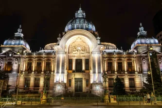 A perfect study in symmetry and light. The iconic CEC Palace is transformed at night, with its magnificent domes and ornate facade bathed in a stunning glow. This architectural masterpiece stands as a proud symbol of Romania's capital.